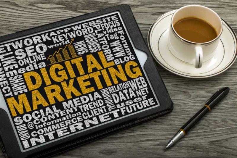 Digital Marketing Strategies for Small Business shown on a tablet n the desk with a coffee.